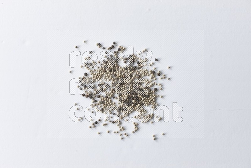 Mixed black and white pepper beads on a white flooring