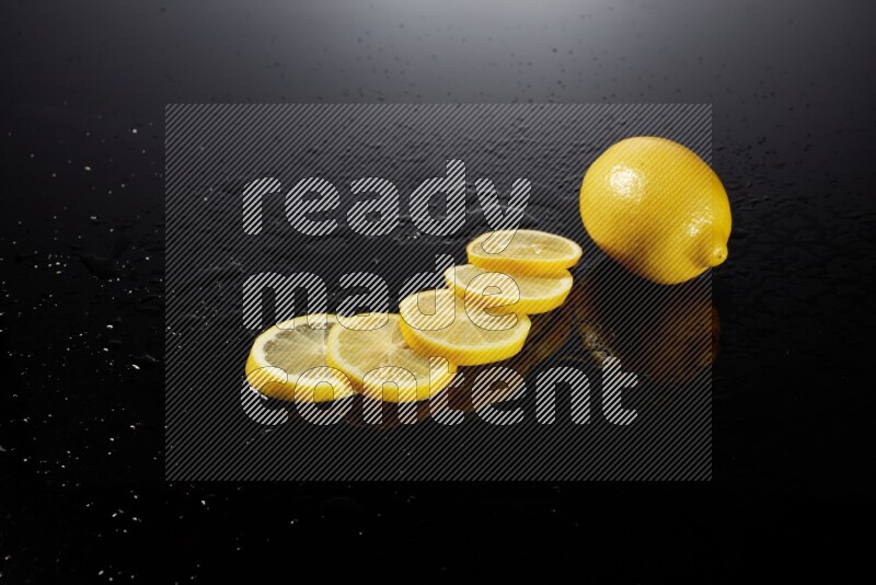 Lemon slices with water drops, and droplets on black background