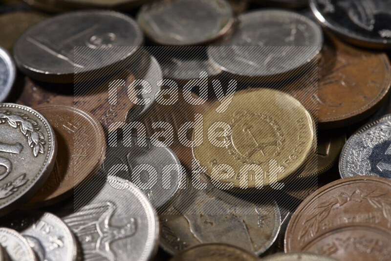 A close-ups of random old coins on black background