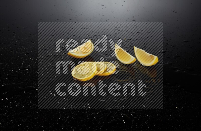 Lemon slices with water drops, and droplets on black background