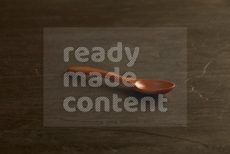 wooden spoon on black slate background