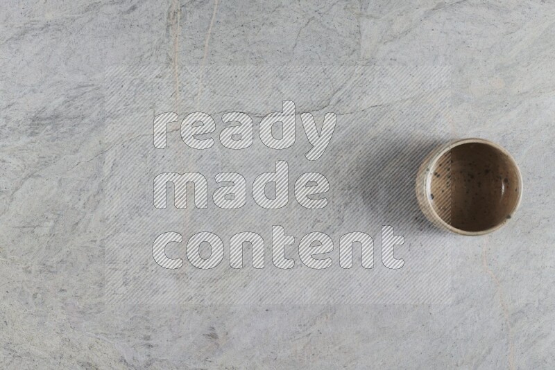 A multicolored pottery Bowl on grey marble background