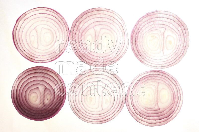 Onion slices on illuminated white background