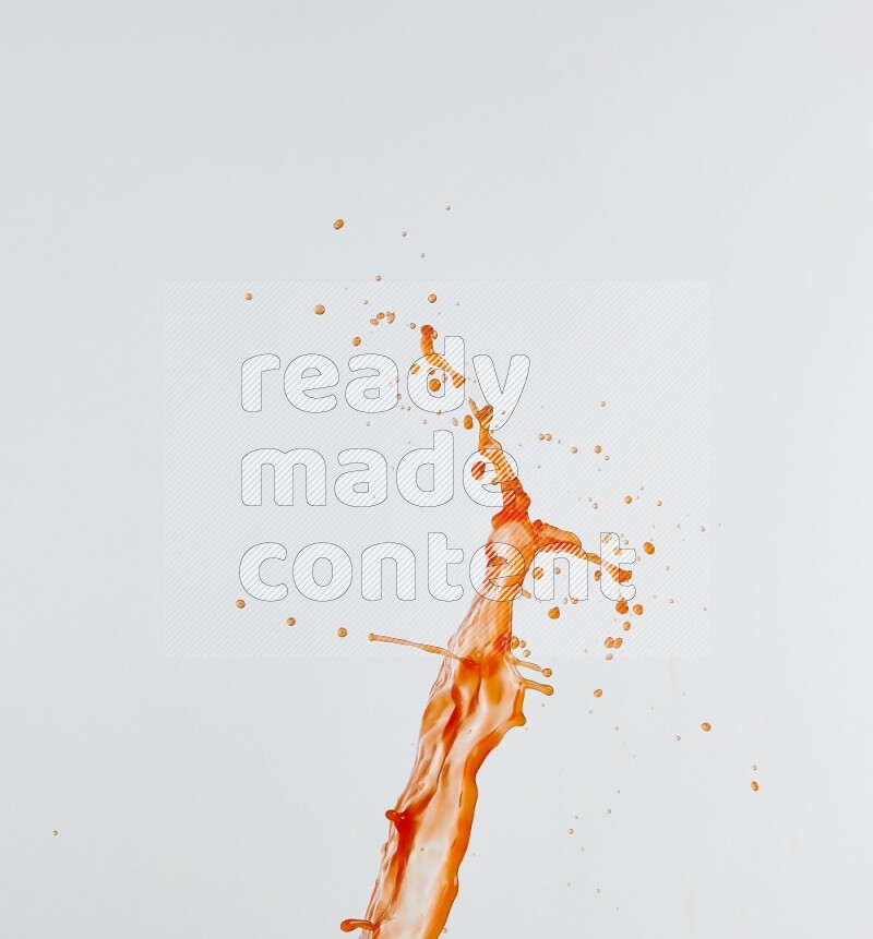 Orange liquid splash and drops on white background