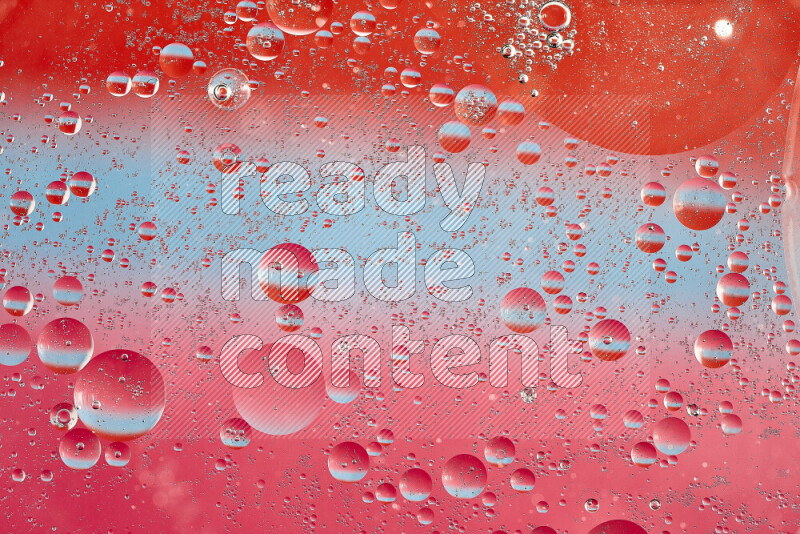 Close-ups of abstract oil bubbles on water surface in shades of blue, red and pink