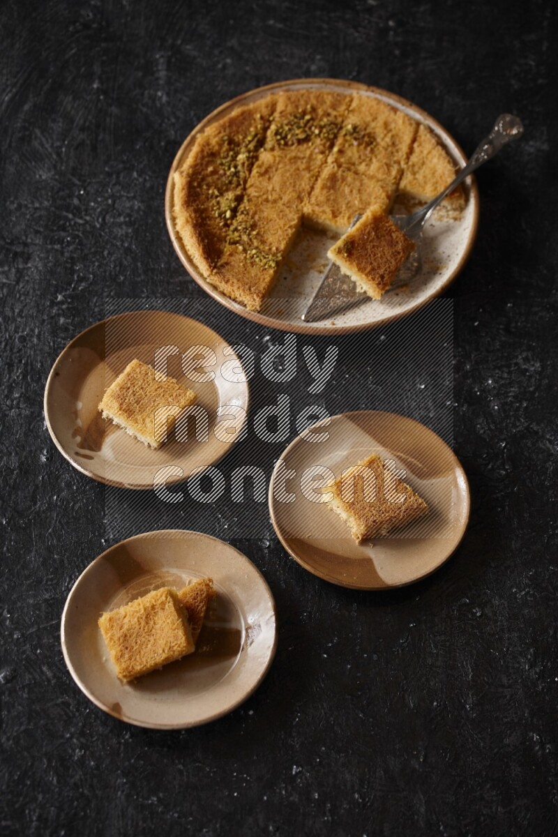 Konafa in different plates in a dark setup