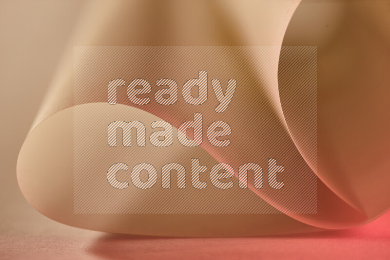 An abstract art piece displaying smooth curves in gold and red gradients created by colored light