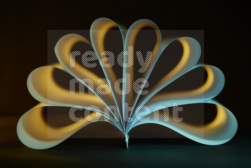 An abstract art piece displaying smooth curves in yellow and green gradients created by colored light