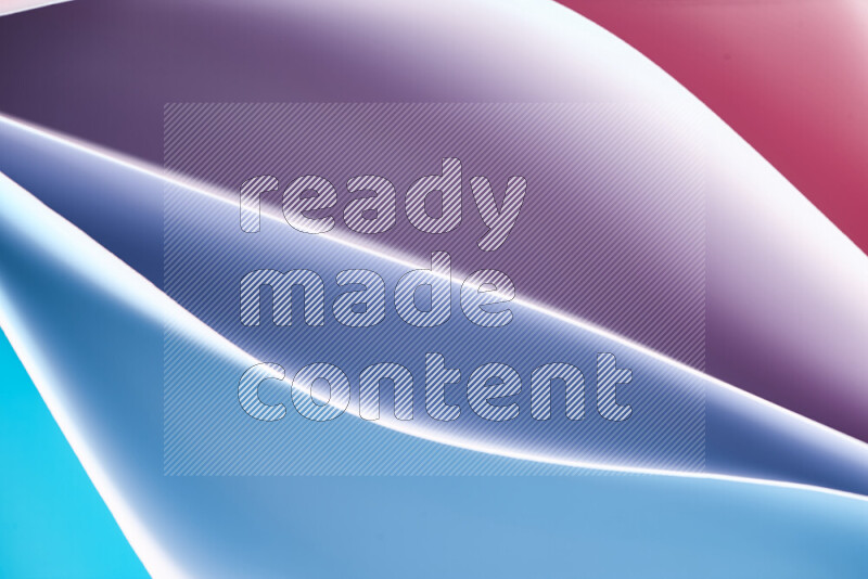 This image showcases an abstract paper art composition with paper curves in blue and red gradients created by colored light