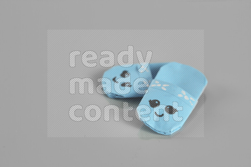 Origami slippers on grey background