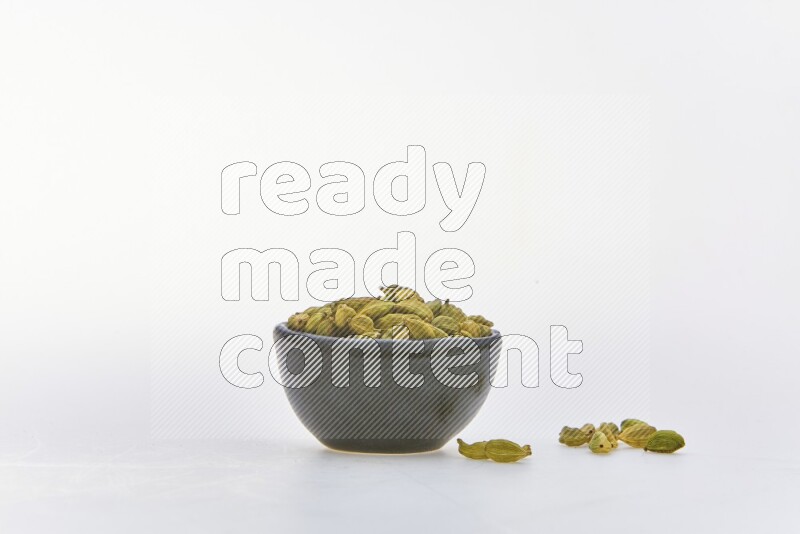 Cardamon in a container on white background