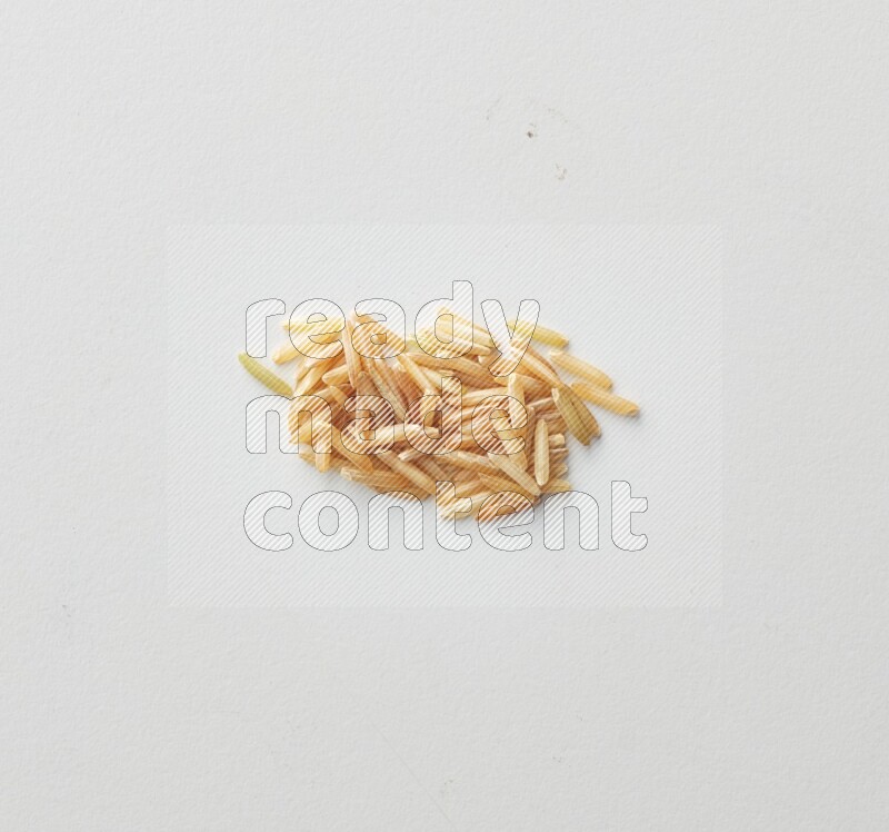 Top-view shot of long grain brown rice on white background