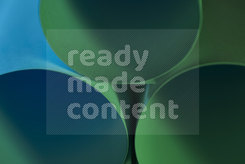 The image shows an abstract paper art with circular shapes in varying shades of green and blue