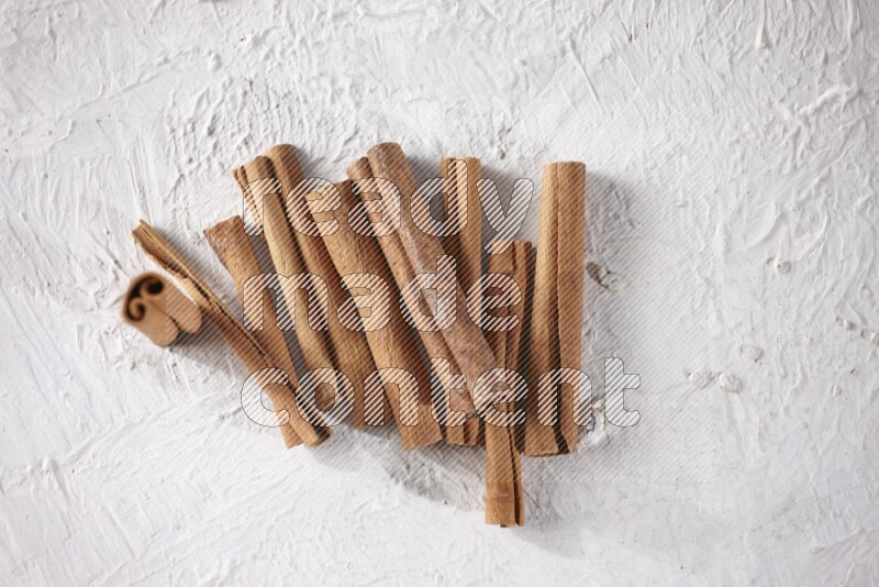 Cinnamon sticks on a textured white background