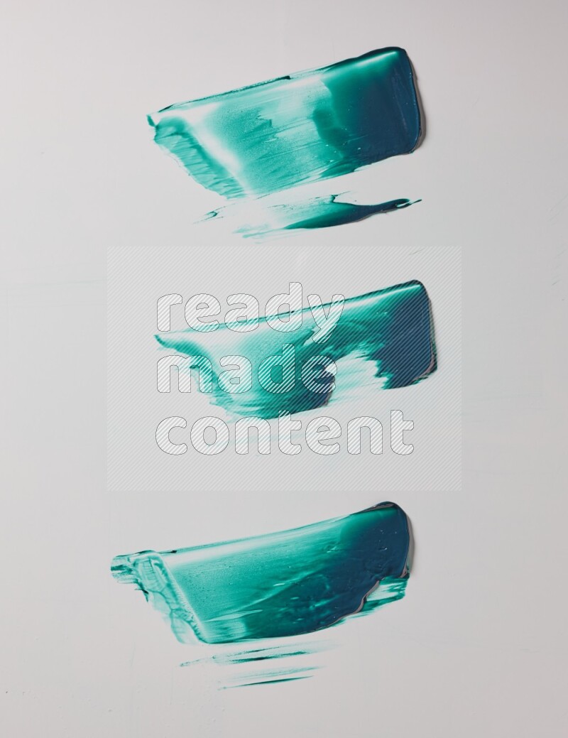 Turquoise painting knife strokes on white background