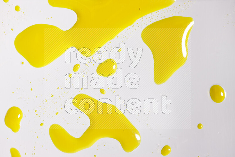 Close-ups of abstract yellow paint droplets on white background
