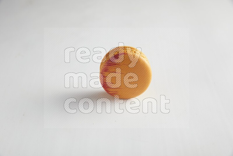 45º Shot of Orange Exotic macaron on white background