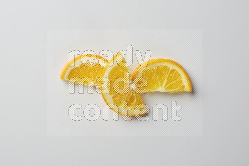 Three halves of an orange slices on white background