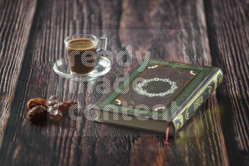 Quran with dates, prayer beads and different drinks all placed on wooden background