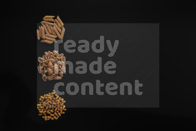 Different pasta types in 3 bunches on black background