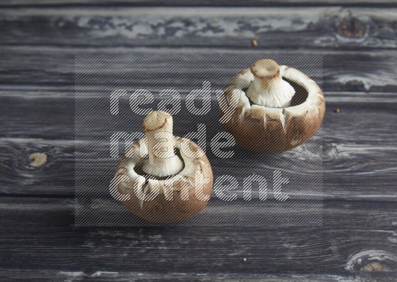 45 degree Cremini  mushrooms on a textured grey background