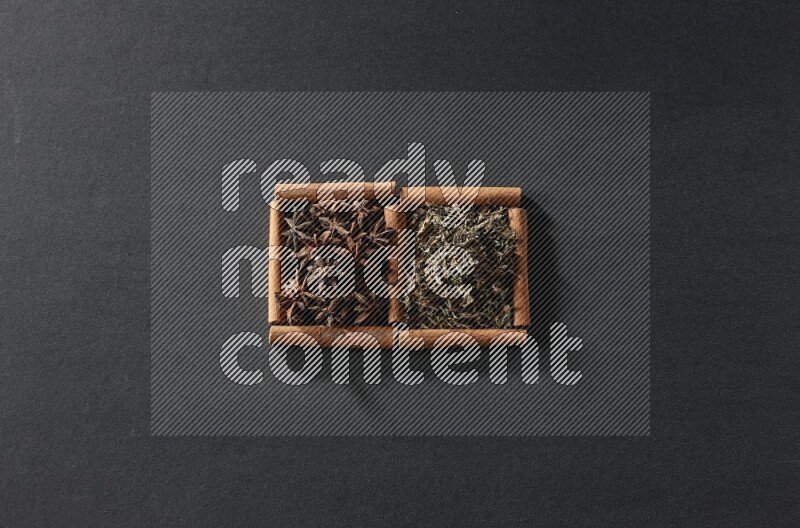 2 squares of cinnamon sticks full of star anise and dried basil on black flooring
