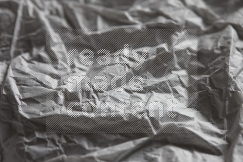 Crumpled notebook sheet on black background