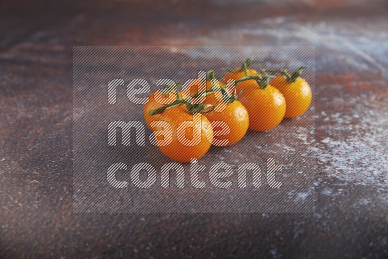 Orange cherry tomato vein on reddish rustic metal background 45 degree