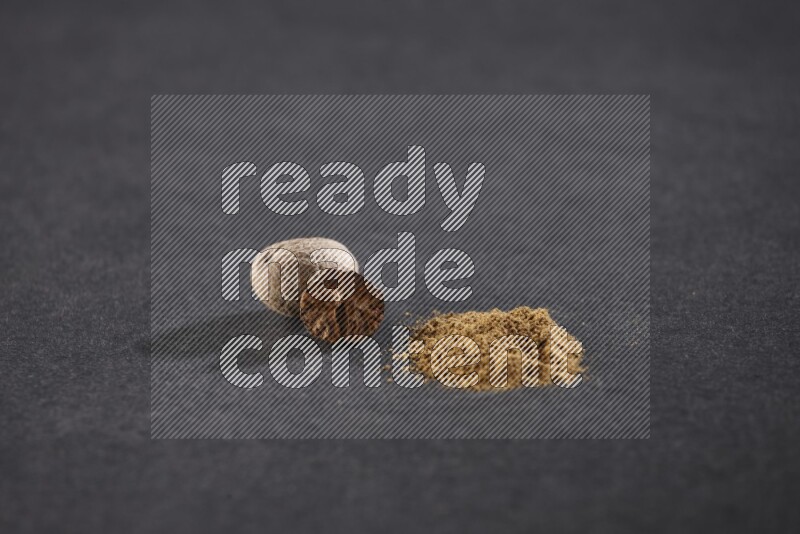 Nutmeg seeds with nutmeg powder beside it on a black flooring in different angles
