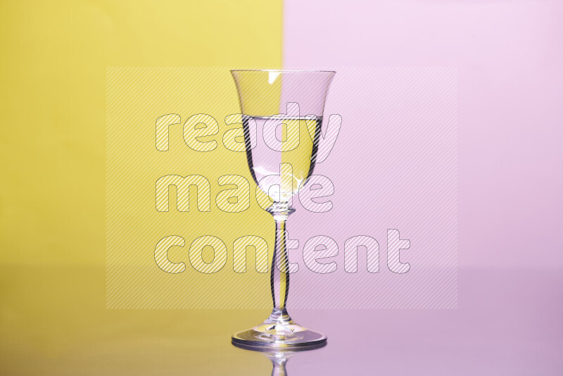 The image features a clear glassware filled with water, set against yellow and rose background