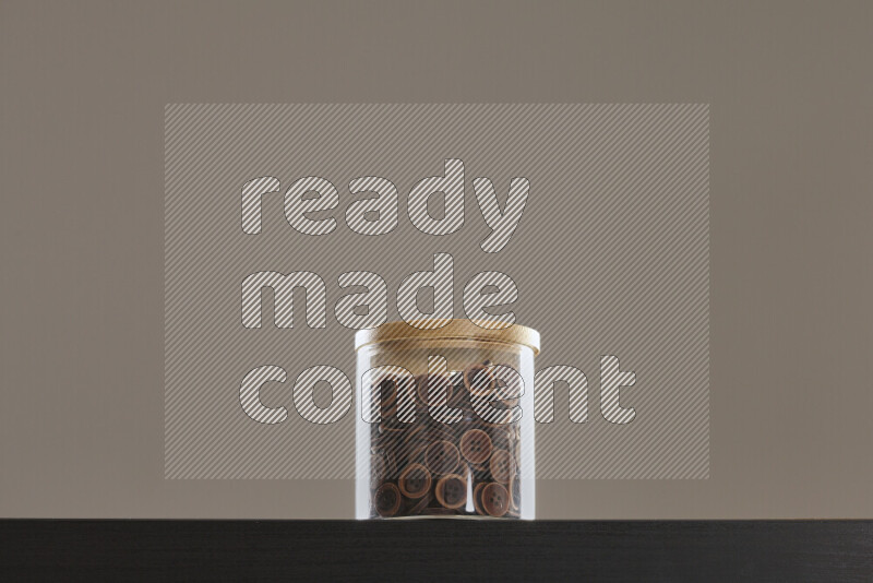 Buttons in a glass jar on black background