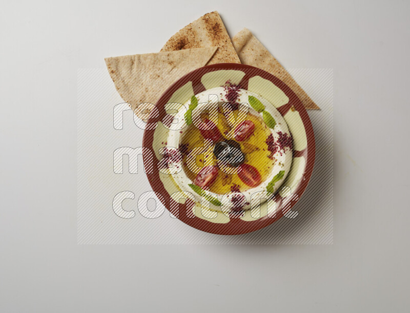 Lebnah garnished with Cherry tomato, mint & sumak  in a traditional plate on a white background