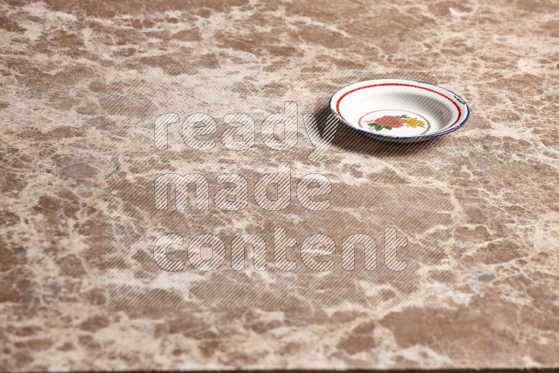 A vintage metal plate on beige marble background