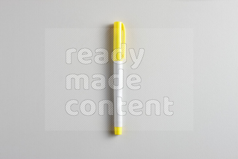 A close-up showing a single coloring pen with a cap on grey background