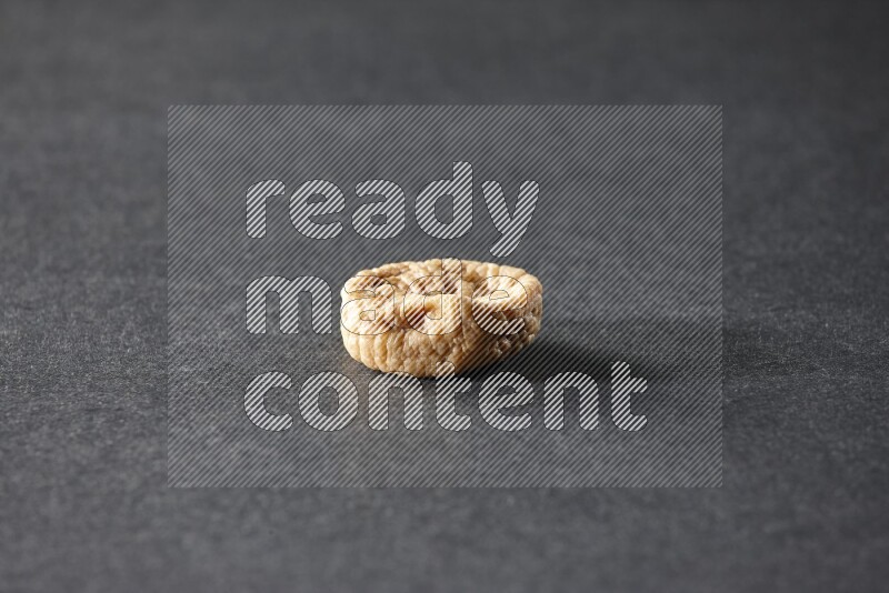A dried fig on a black background in different angles