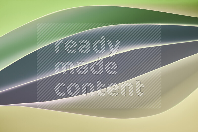 This image showcases an abstract paper art composition with paper curves in green and different warm gradients created by colored light