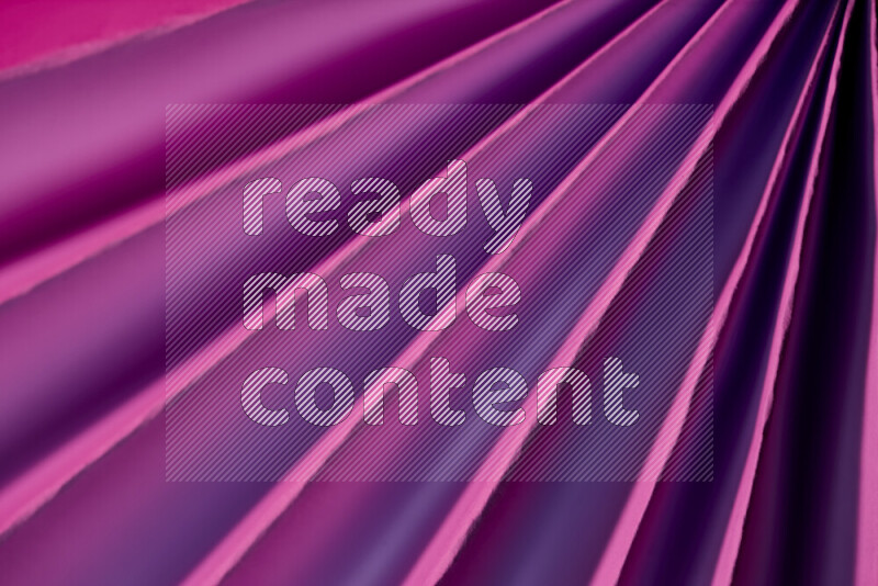 An image presenting an abstract paper pattern of lines in purple tones