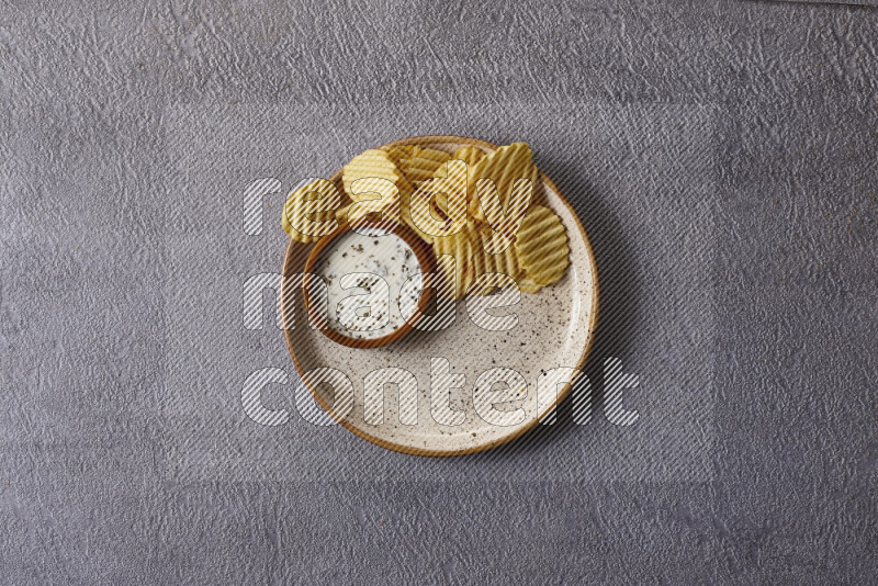 Assorted snacks in pottery bowls on grey background