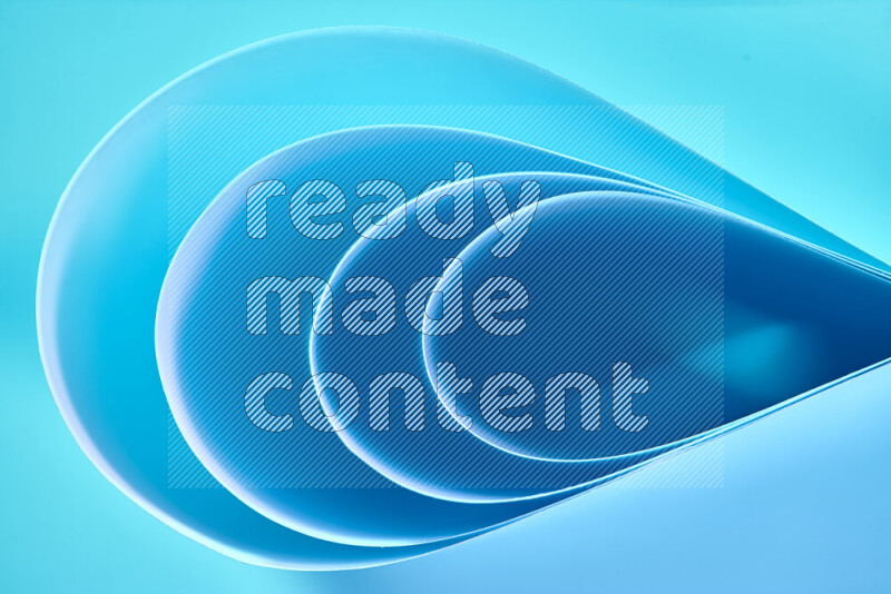 An abstract art of paper folded into smooth curves in blue gradients