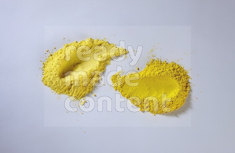 Yellow powder smears on white background