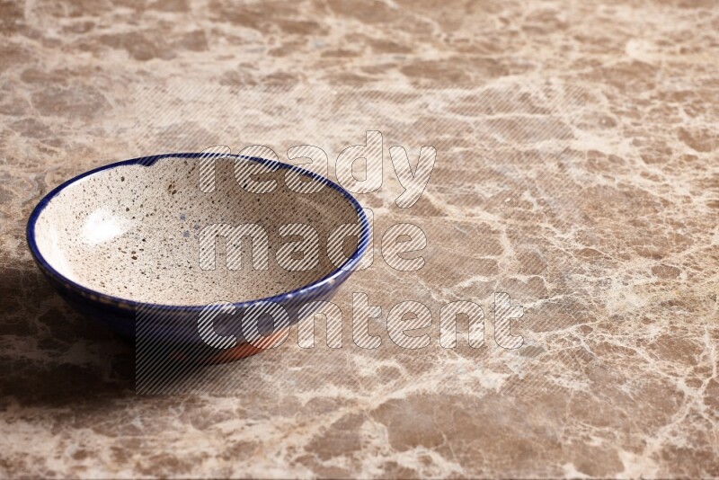Multicolored Pottery Bowl on Beige Marble Flooring
