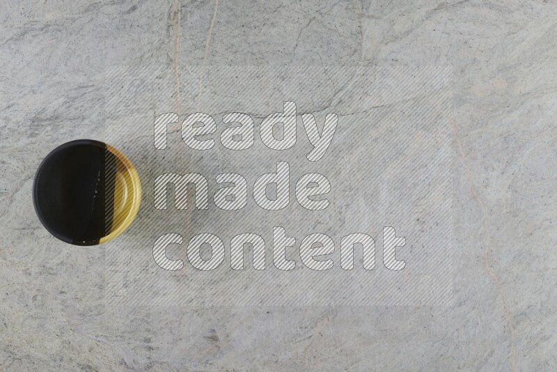 A multicolored pottery Bowl on grey marble background