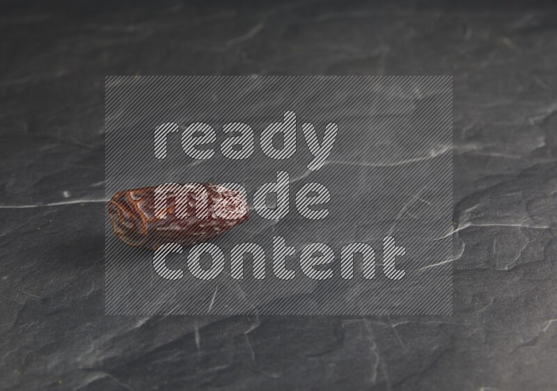 one madjoul date on a black textured background