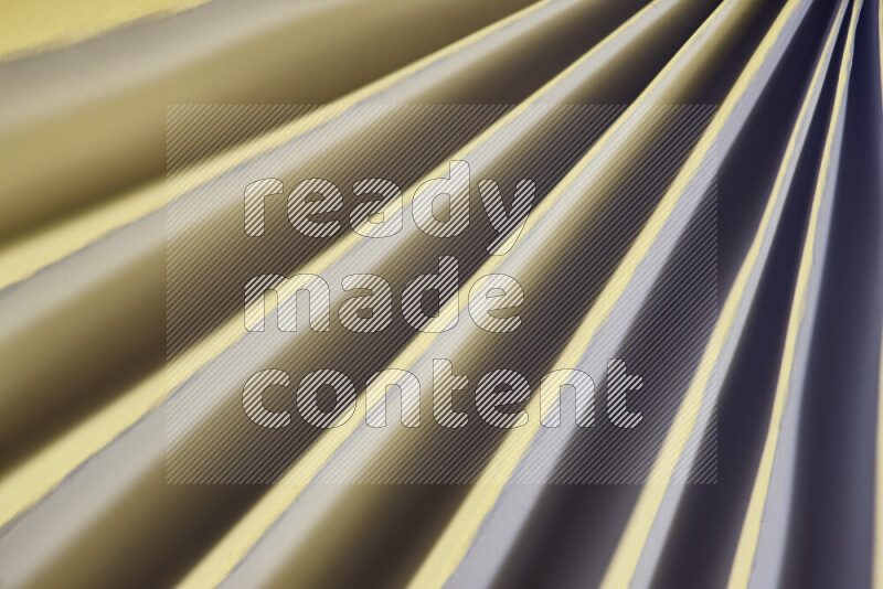An image presenting an abstract paper pattern of lines in white and gold tones