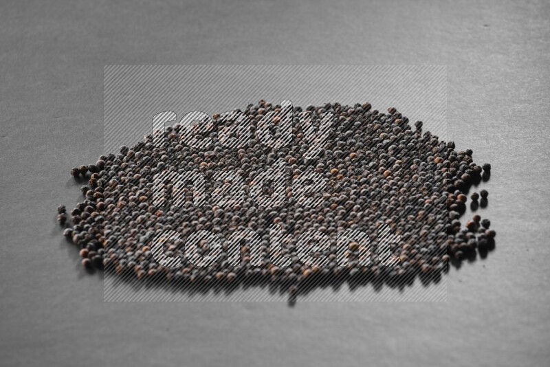Black pepper on a black flooring