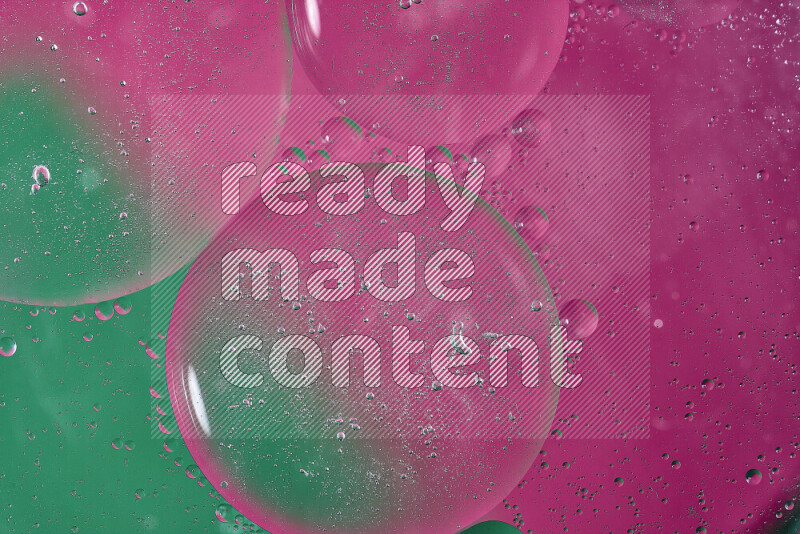 Close-ups of abstract oil bubbles on water surface in shades of green and pink