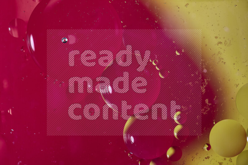 Close-ups of abstract oil bubbles on water surface in shades of red and yellow
