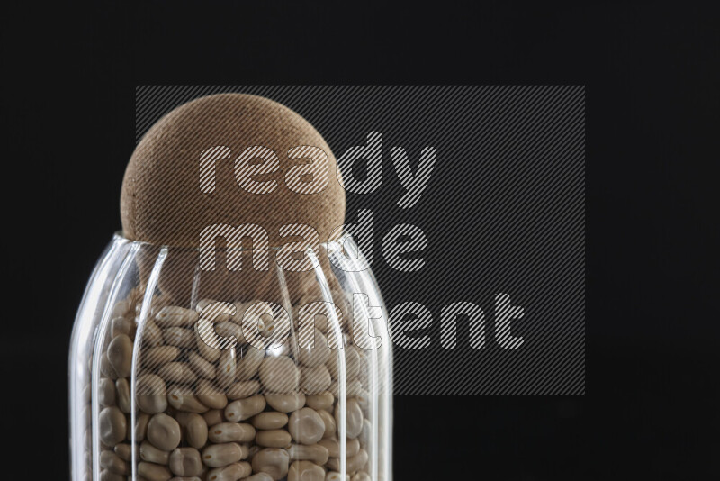 Lupin Beans in a glass jar on black background