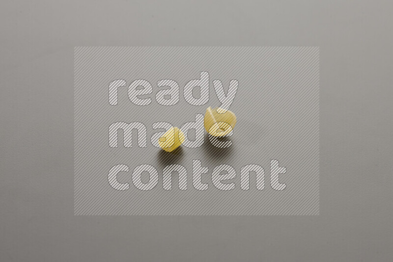 Small rings pasta with other types of pasta on grey background