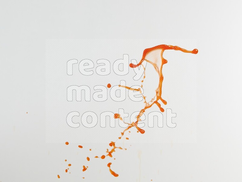 Orange liquid splash and drops on white background
